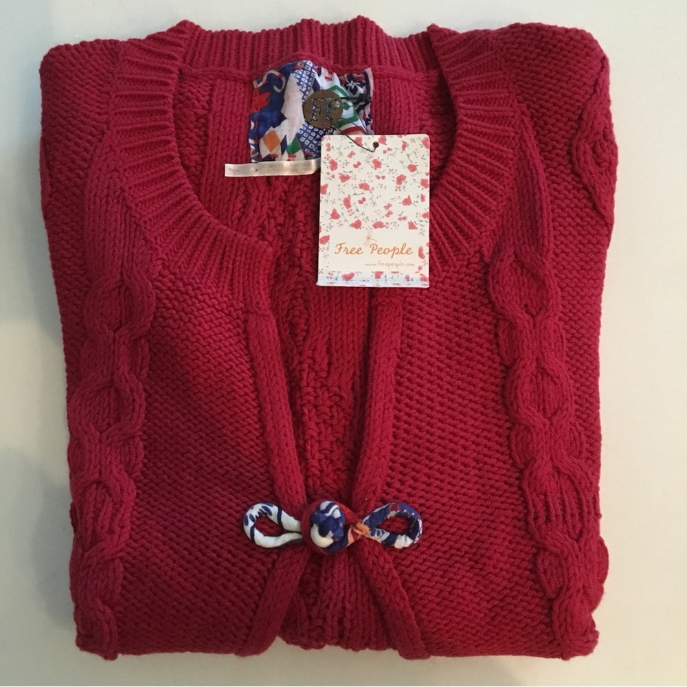 Free People short sleeved red cable knit cardigan with single button closure